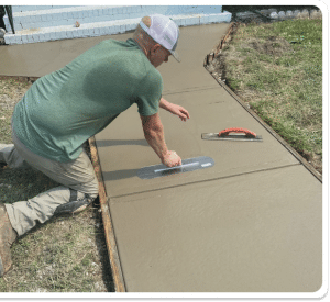 Smooth concrete walkway being finished with a trowel, bordered by wood formwork in Richmond VA