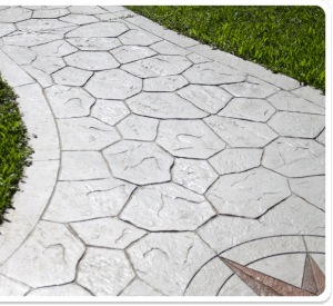 Stamped concrete walkway with random stone pattern, compass rose, and grass surroundings in Richmond VA