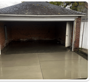Freshly poured concrete garage floor with control joints in Richmond VA