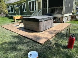 Stamped concrete patio with ashlar slate pattern surrounding a hot tub and leading to a screened porch in Midlothian VA