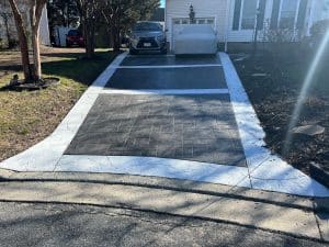 Stamped concrete driveway with dark grey ashlar pattern and light gray border in Henrico VA