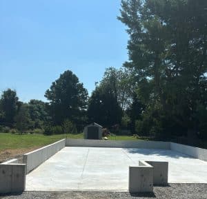 Concrete foundation slab with perimeter walls and expansion joints in a backyard in Richmond VA