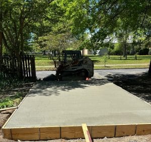 Smooth finished concrete slab with wooden formwork and nearby construction equipment in Goochland VA