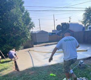 Fresh concrete patio being poured with crew, tools, and a cement truck in Williamsburg VA