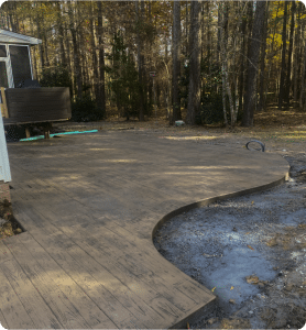 Stamped concrete patio with wood-plank pattern, curved edge, and dark border in Chesterfield VA