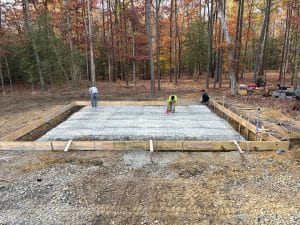 Pole barn slab foundation with gravel base and rebar grid, framed for pouring in Chesterfield VA