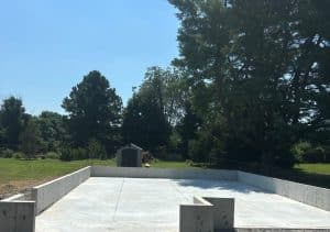 Gray concrete foundation with surrounding walls, and tree-filled background in Chesterfield VA