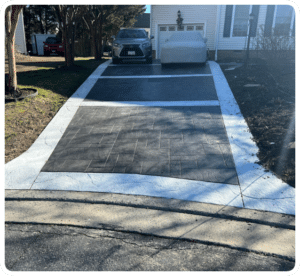 Stamped concrete driveway with dark slate pattern and light gray border leading to garage in Richmond VA