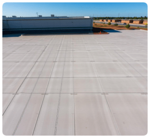 Broom-finished concrete parking lot with expansion joints beside a large building in Richmond VA