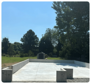 Concrete foundation walls and slab with expansion joints, surrounded by green landscape in Richmond VA